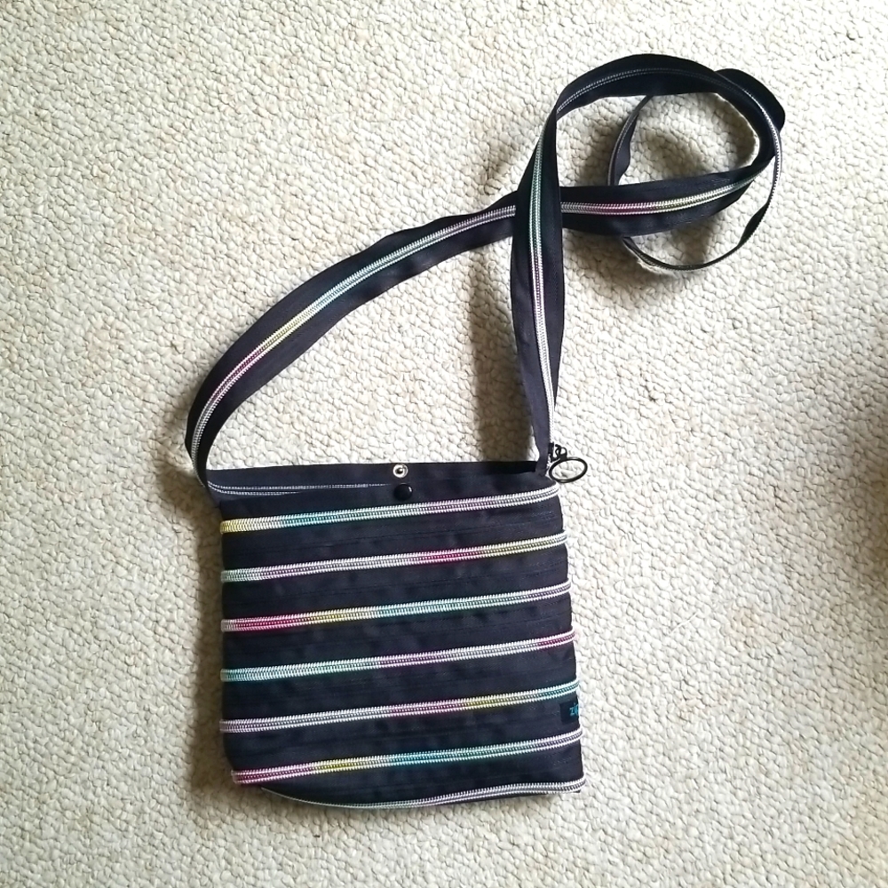 Crossbody Black and Rainbow Colored Zipper Lightweight Bag with snap close.